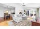 Bright living room with large couch, hardwood floors, and access to outdoor patio at 706 Kensington Dr, Chapel Hill, NC 27514