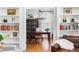 Office featuring hardwood floors, built-in shelving, with views to another living space at 706 Kensington Dr, Chapel Hill, NC 27514