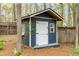 Exterior view of storage shed with neutral colors, windows, and white door at 706 Kensington Dr, Chapel Hill, NC 27514