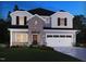 Charming two-story home with a stone facade, two-car garage, and professionally landscaped yard at 709 Deschutes Dr, Garner, NC 27529