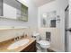 Bathroom featuring a wooden vanity with sink, toilet, and medicine cabinet at 711 Melanie St, Durham, NC 27704
