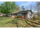 Charming single-story brick home with a well-maintained lawn, surrounded by mature trees at 711 Melanie St, Durham, NC 27704