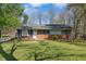 Charming brick home with well-maintained lawn and mature trees offering great curb appeal at 711 Melanie St, Durham, NC 27704