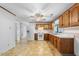 Open kitchen area with wood cabinets and updated appliances ready for your culinary creations at 711 Melanie St, Durham, NC 27704