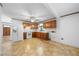 Functional kitchen featuring wood cabinetry, laminate countertops, and vinyl flooring at 711 Melanie St, Durham, NC 27704