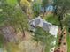 An aerial shot showcasing the home's beautiful roof, extensive landscaping, and privacy trees at 7336 Barham Hollow Dr, Wake Forest, NC 27587