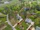 An aerial shot showcases the home set within a community with lush trees at 7336 Barham Hollow Dr, Wake Forest, NC 27587