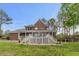 Expansive backyard featuring a classic brick home with a spacious white lattice deck, perfect for outdoor living at 7336 Barham Hollow Dr, Wake Forest, NC 27587