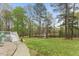 Beautiful backyard featuring a pond viewed from the deck with a stone path and lush green lawn at 7336 Barham Hollow Dr, Wake Forest, NC 27587