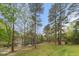 Serene backyard setting with mature trees surrounding a tranquil pond, offering a peaceful and private retreat at 7336 Barham Hollow Dr, Wake Forest, NC 27587