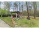 Backyard with a gazebo, seating, and landscaped areas, perfect for outdoor enjoyment at 7336 Barham Hollow Dr, Wake Forest, NC 27587