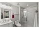 Bright, updated bathroom with white marble tile, glass enclosed shower, and modern fixtures at 7336 Barham Hollow Dr, Wake Forest, NC 27587