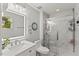 Modern bathroom with marble shower, stylish fixtures, and plenty of natural light at 7336 Barham Hollow Dr, Wake Forest, NC 27587