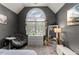 Cozy bedroom featuring a large window, seating area, and neutral color palette at 7336 Barham Hollow Dr, Wake Forest, NC 27587