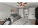 Comfortable bedroom with a sofa, ceiling fan, and view into an en-suite bathroom at 7336 Barham Hollow Dr, Wake Forest, NC 27587
