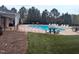 Inviting community pool area with ample seating, perfect for relaxing and enjoying the outdoors at 7336 Barham Hollow Dr, Wake Forest, NC 27587