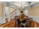 Elegant dining room with hardwood floors, coffered ceilings, chandelier, and staircase at 7336 Barham Hollow Dr, Wake Forest, NC 27587