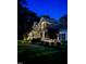 Night shot of exterior featuring a charming brick home with a welcoming front porch, and lush landscaping at 7336 Barham Hollow Dr, Wake Forest, NC 27587