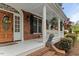 Charming brick home with front porch, lion statue, black shutters, and landscaped front yard at 7336 Barham Hollow Dr, Wake Forest, NC 27587