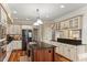 This stunning kitchen features a center island, stainless steel appliances, and custom cabinetry for a modern and stylish look at 7336 Barham Hollow Dr, Wake Forest, NC 27587