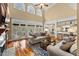 Bright living room boasts hardwood floors, large windows, a fireplace, and comfortable seating for relaxing and entertaining guests at 7336 Barham Hollow Dr, Wake Forest, NC 27587