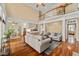 Open-concept living room features hardwood floors, a high ceiling, and a view of the second floor balcony at 7336 Barham Hollow Dr, Wake Forest, NC 27587