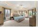 Spacious main bedroom features a tray ceiling, carpeted floors, and a large window for lots of natural light at 7336 Barham Hollow Dr, Wake Forest, NC 27587