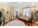 Comfortable sitting room featuring hardwood floors, vintage sofa, and sheer curtains at 7336 Barham Hollow Dr, Wake Forest, NC 27587