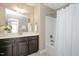 Bathroom featuring a dark vanity, a bathtub, and an enclosed shower at 800 Laurel Garden Way, Cary, NC 27513