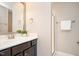 Bathroom featuring a single sink vanity, mirror, shower and neutral colored walls at 800 Laurel Garden Way, Cary, NC 27513