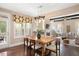 Open concept dining area with hardwood floors, a large window, and a view into the living room at 800 Laurel Garden Way, Cary, NC 27513