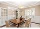 Bright dining room with hardwood floors, large windows, and a wooden table set for six at 800 Laurel Garden Way, Cary, NC 27513