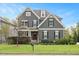Charming two-story home with gray siding, black shutters, a manicured lawn, and mature landscaping at 800 Laurel Garden Way, Cary, NC 27513