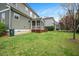 The home's back exterior with a covered porch and green grassy lawn at 800 Laurel Garden Way, Cary, NC 27513