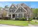 Charming home with gray siding, black shutters, landscaped yard, and inviting front porch at 800 Laurel Garden Way, Cary, NC 27513