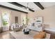 A spacious living room with a ceiling fan, wooden beams, and lots of natural light at 800 Laurel Garden Way, Cary, NC 27513
