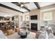 A living room with a fireplace, built-in shelves, and open floor plan to the kitchen at 800 Laurel Garden Way, Cary, NC 27513