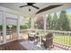 View of screened porch featuring two wicker chairs and view of backyard at 800 Laurel Garden Way, Cary, NC 27513