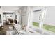 Bright dining room with large windows, modern chandelier, and seating for six at 817 Central Pk Dr, Raleigh, NC 27604