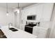 Contemporary kitchen featuring white cabinets, stainless steel appliances, and quartz countertops at 817 Central Pk Dr, Raleigh, NC 27604