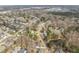 Scenic aerial view of a residential neighborhood with tree-lined streets and a serene pond at 8308 Buck Crossing Dr, Durham, NC 27713