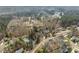 Picturesque aerial view of homes near a tranquil pond surrounded by a natural forest landscape at 8308 Buck Crossing Dr, Durham, NC 27713