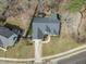 Stunning aerial view of a charming home with a long driveway and lush, landscaped backyard and patio at 8308 Buck Crossing Dr, Durham, NC 27713