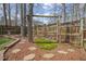Landscaped backyard with a play area that includes a swing set and mature trees at 8308 Buck Crossing Dr, Durham, NC 27713