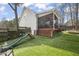 Screened-in porch overlooking a backyard with a slide, ideal for Gathering fun at 8308 Buck Crossing Dr, Durham, NC 27713