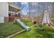 Spacious backyard with a slide and patio seating, perfect for entertaining at 8308 Buck Crossing Dr, Durham, NC 27713