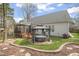Backyard features a hot tub, screened porch, landscaped yard, and serene outdoor space at 8308 Buck Crossing Dr, Durham, NC 27713