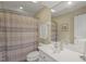 Neutral bathroom features shower with curtain, white fixtures, and a large mirror at 8308 Buck Crossing Dr, Durham, NC 27713