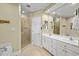 Bright bathroom showcasing double vanity, glass enclosed shower, and separate soaking tub at 8308 Buck Crossing Dr, Durham, NC 27713
