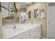 Bathroom featuring double sinks, bright vanity, and enclosed shower/tub combo at 8308 Buck Crossing Dr, Durham, NC 27713